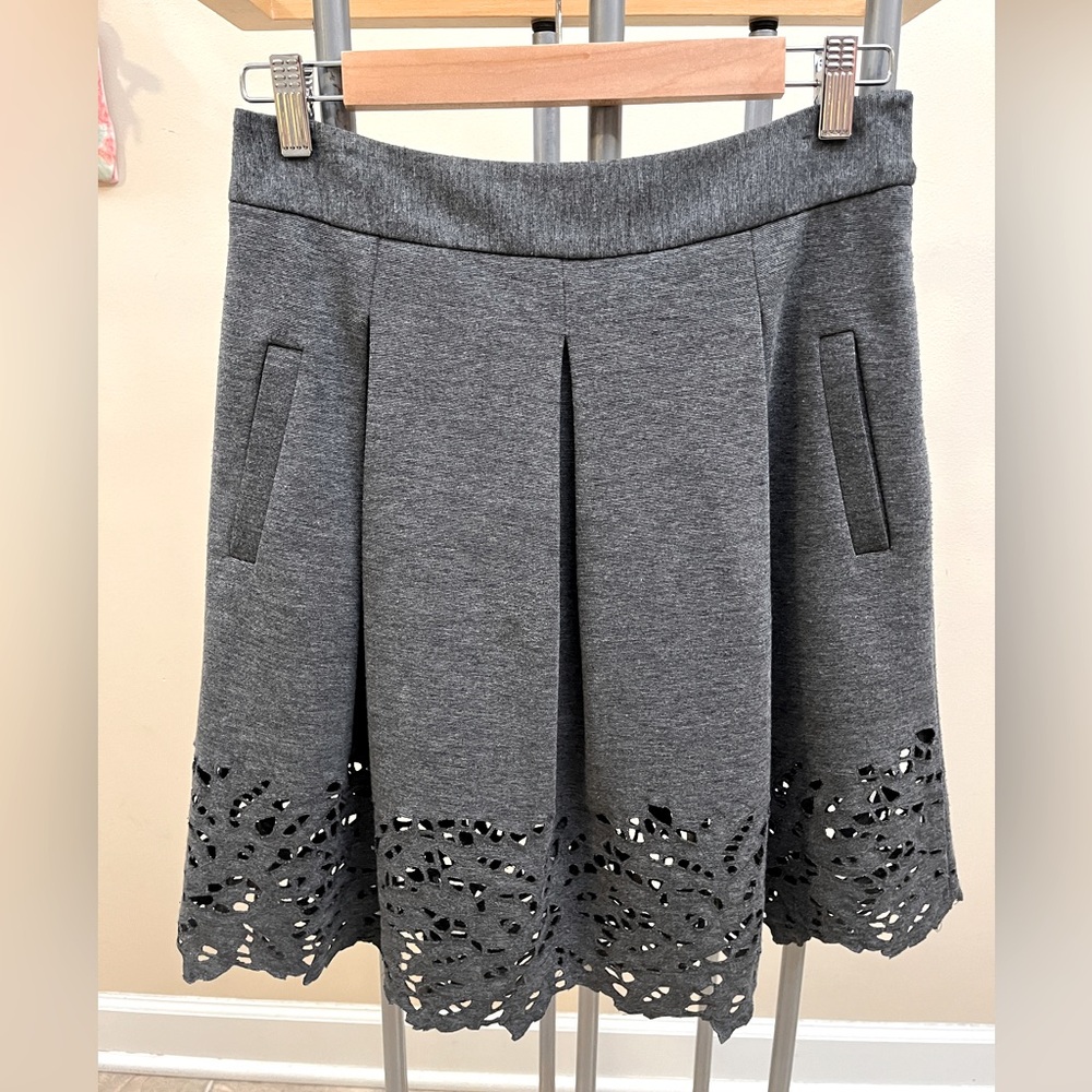 Pleated skirt with bottom eyelet design and pockets!